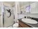 Bathroom featuring a walk-in shower with a mermaid design, a vanity, and a mirrored medicine cabinet at 10890 Stuart Ct, Westminster, CO 80031