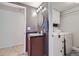 Bathroom with single sink vanity, laundry area, and gray walls at 10890 Stuart Ct, Westminster, CO 80031