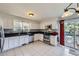 Well-lit kitchen featuring white cabinetry, stainless steel appliances, and tile backsplash at 10890 Stuart Ct, Westminster, CO 80031