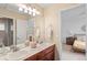 Shared bathroom with double sinks and a view into a bedroom at 19064 Eagle Ridge Dr, Golden, CO 80401