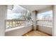 Outdoor balcony with wood flooring, white railings, and view of greenery and neighborhood at 5640 S Marshall St, Denver, CO 80123