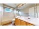 Bathroom featuring a shower-tub combo, double sink vanity, and ample mirror space at 5640 S Marshall St, Denver, CO 80123