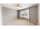 Bedroom with a ceiling fan, carpeting, and a bright window providing natural light at 5640 S Marshall St, Denver, CO 80123