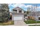 Inviting two-story home featuring a gray exterior, balcony, well-kept lawn, and convenient two-car garage at 5640 S Marshall St, Denver, CO 80123
