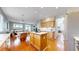 Open kitchen with an island that flows into the dining and living areas with wood floors at 5640 S Marshall St, Denver, CO 80123