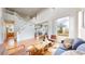 Open-concept living room featuring a grand staircase, hardwood floors, and a cozy fireplace, perfect for gatherings at 5640 S Marshall St, Denver, CO 80123