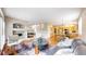 Spacious living area seamlessly connects to the kitchen, featuring hardwood floors, a fireplace, and ample seating at 5640 S Marshall St, Denver, CO 80123