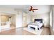 Primary bedroom features wood floors, bedroom suite and an arched doorway to bathroom at 5640 S Marshall St, Denver, CO 80123