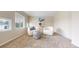 Bright seating area showcasing plush chairs, a textured ottoman, and sunlit windows at 5640 S Marshall St, Denver, CO 80123