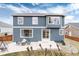 Well-maintained backyard featuring a concrete patio, mature trees, and partially fenced yard at 14669 Eagle River Run, Broomfield, CO 80023