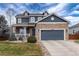 Charming two-story home with stone accents, dormers, and a covered front porch at 14669 Eagle River Run, Broomfield, CO 80023