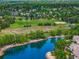 High-angle view of homes near a lake, a baseball field, and trees, highlighting the neighborhood's amenities at 7955 S Bemis St, Littleton, CO 80120