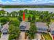 Aerial view of a lakeside home with a well-manicured yard and mature trees at 7955 S Bemis St, Littleton, CO 80120