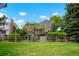 Large, fenced backyard with a green lawn, mature trees, and a sense of seclusion creating a private oasis at 7955 S Bemis St, Littleton, CO 80120