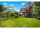 Lush backyard with a well-manicured lawn, mature trees, and a multi-level deck perfect for outdoor entertaining at 7955 S Bemis St, Littleton, CO 80120