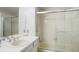 Bright bathroom features a clean aesthetic with a shower/tub combination and a mirrored vanity area at 7955 S Bemis St, Littleton, CO 80120