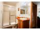 Well-lit bathroom featuring a shower with glass door, vanity with sink, and a private toilet area for convenience at 7955 S Bemis St, Littleton, CO 80120