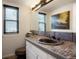 Stylish bathroom featuring a vessel sink with a unique stone countertop and modern fixtures at 7955 S Bemis St, Littleton, CO 80120