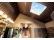 Stylish bathroom with a skylight, double vanity, modern fixtures, and elegant tile work at 7955 S Bemis St, Littleton, CO 80120