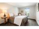 Cozy bedroom with a comfortable bed, side table, and natural light from the window at 7955 S Bemis St, Littleton, CO 80120