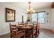 Warm dining room with hardwood floors, a large window, and a traditional light fixture at 7955 S Bemis St, Littleton, CO 80120