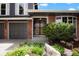 Close up of home exterior featuring brick detail, storm door and manicured landscaping at 7955 S Bemis St, Littleton, CO 80120