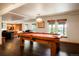Recreation room with a well-maintained pool table and hardwood floors, perfect for entertaining guests at 7955 S Bemis St, Littleton, CO 80120