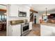 Kitchen with stainless steel range, and microwave, white cabinets, and tile flooring at 7955 S Bemis St, Littleton, CO 80120