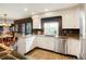 Kitchen with white cabinets, stainless steel appliances, granite countertops, and tile flooring at 7955 S Bemis St, Littleton, CO 80120
