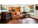 Cozy living room with hardwood floors, custom built-ins, and an abundance of natural light creating a warm atmosphere at 7955 S Bemis St, Littleton, CO 80120