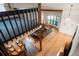 Open concept living room with hardwood floors, exposed wood beams, and an airy feel with a view from the loft at 7955 S Bemis St, Littleton, CO 80120