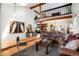 Open-concept living room with high ceilings, hardwood floors, and a cozy seating area at 7955 S Bemis St, Littleton, CO 80120