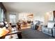 Open-concept living area with a dining area, kitchen, and comfortable leather seating at 7955 S Bemis St, Littleton, CO 80120