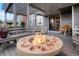 Outdoor porch with a fire pit, wooden bench seating, and a view of surrounding buildings at 7955 S Bemis St, Littleton, CO 80120