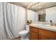 Bathroom featuring a wood vanity with a white countertop, a shower with a curtain, and neutral walls at 8600 E Alameda Ave # 21-208, Denver, CO 80247