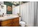 Bathroom featuring a wood vanity with a white countertop, a shower with a curtain, and green walls at 8600 E Alameda Ave # 21-208, Denver, CO 80247
