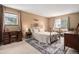 Inviting bedroom with large windows, carpeted floors, and an ornate metal bed frame at 8600 E Alameda Ave # 21-208, Denver, CO 80247