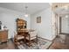 Cozy dining area featuring a wood table, four chairs, overhead lighting, and hardwood floors at 8600 E Alameda Ave # 21-208, Denver, CO 80247