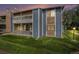 Attractive two-story condominium with blue siding, stone accents, two balconies, and a lush lawn at 8600 E Alameda Ave # 21-208, Denver, CO 80247