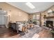 Bright living room with a skylight, fireplace with stone surround, hardwood floors, and sliding glass doors at 8600 E Alameda Ave # 21-208, Denver, CO 80247