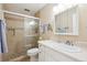 Bright bathroom featuring tiled walk-in shower, large mirror and vanity with white cabinets at 9625 E Center Ave # 5D, Denver, CO 80247