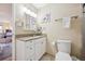 Well-lit bathroom with a granite countertop vanity, mirror and modern fixtures, exuding style and functionality at 9625 E Center Ave # 5D, Denver, CO 80247