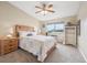 Bedroom featuring a full bed, a dresser, a ceiling fan and a large window with natural light at 9625 E Center Ave # 5D, Denver, CO 80247