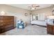 Bedroom featuring a comfy bed, sitting area, and large dresser with neutral tones at 9625 E Center Ave # 5D, Denver, CO 80247