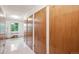 Hallway featuring storage unit closets with white doors and a window at 9625 E Center Ave # 5D, Denver, CO 80247