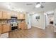 Well-lit kitchen featuring warm wood flooring, stainless steel appliances, ample counter space, and decorative backsplash at 9625 E Center Ave # 5D, Denver, CO 80247