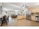 Bright, open kitchen-living room combo featuring wood floors, ample cabinet space, granite countertops, and stainless steel appliances at 9625 E Center Ave # 5D, Denver, CO 80247