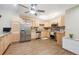 This kitchen showcases stainless steel appliances, light wood cabinets, granite countertops, and warm wood flooring at 9625 E Center Ave # 5D, Denver, CO 80247