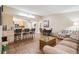 Open-concept living and dining area with breakfast bar and wooden floors throughout, great for modern living at 9625 E Center Ave # 5D, Denver, CO 80247