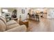 Inviting living room with hardwood floors, a kitchen island, and a view of a modern kitchen in an open concept design at 9625 E Center Ave # 5D, Denver, CO 80247